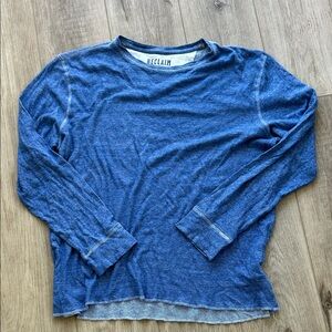 Blue long sleeve Reclaim shirt.